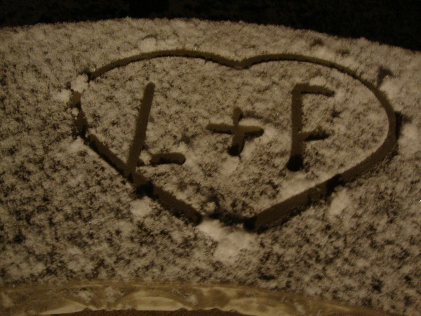 Our initials on snowy bench
