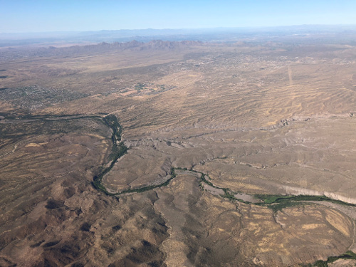 Green next to river, brown otherwise