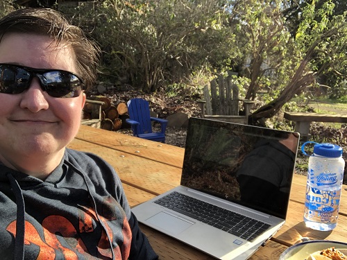 Me sitting at picnic table on sunny day