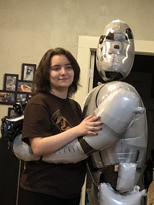 Marisol dancing with life-size Storm Trooper balloon