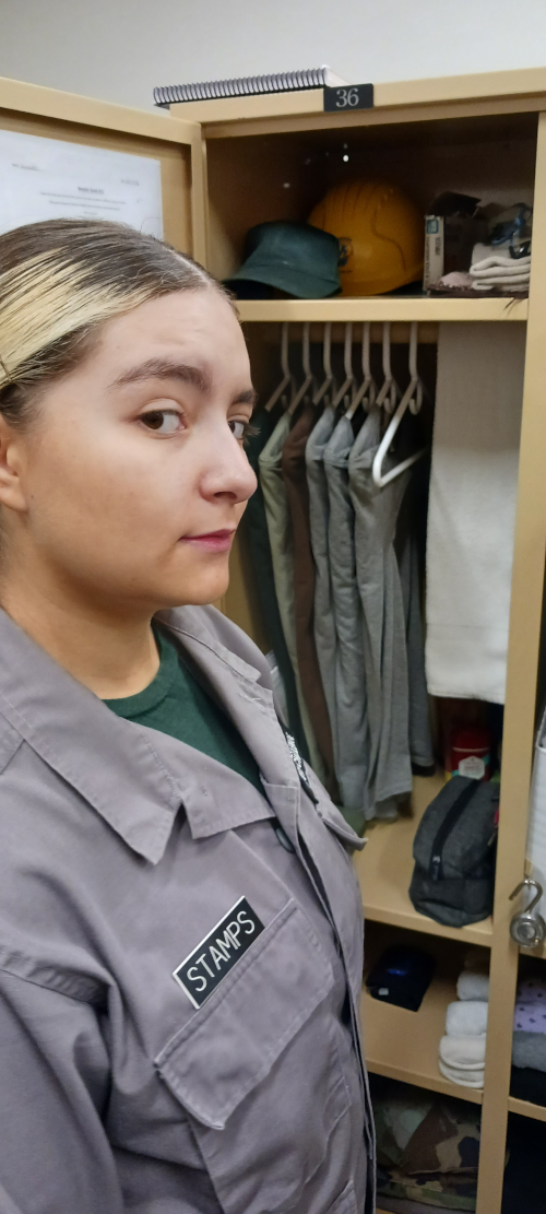 Marisol in front of her clean locker